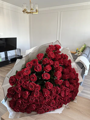 A joyful family arranging freshly cut roses enhanced by rose aroma spray in a cozy living room.
