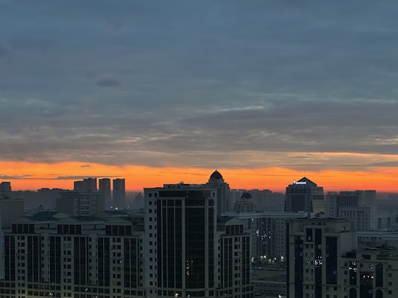 A panoramic view of Richmond’s downtown skyline at dusk, highlighting mid-rise commercial buildings and mixed-use developments.