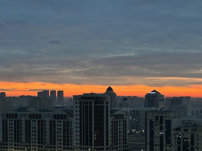 A panoramic view of Riyadh's skyline at dusk, highlighting its vibrant business district.