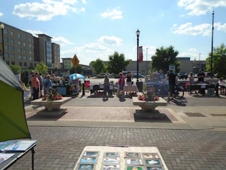A vibrant African marketplace bustling with trade activity under a bright blue sky.