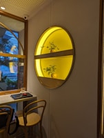 Stylish shelf decorated with plants and subtle lighting creating a welcoming atmosphere.