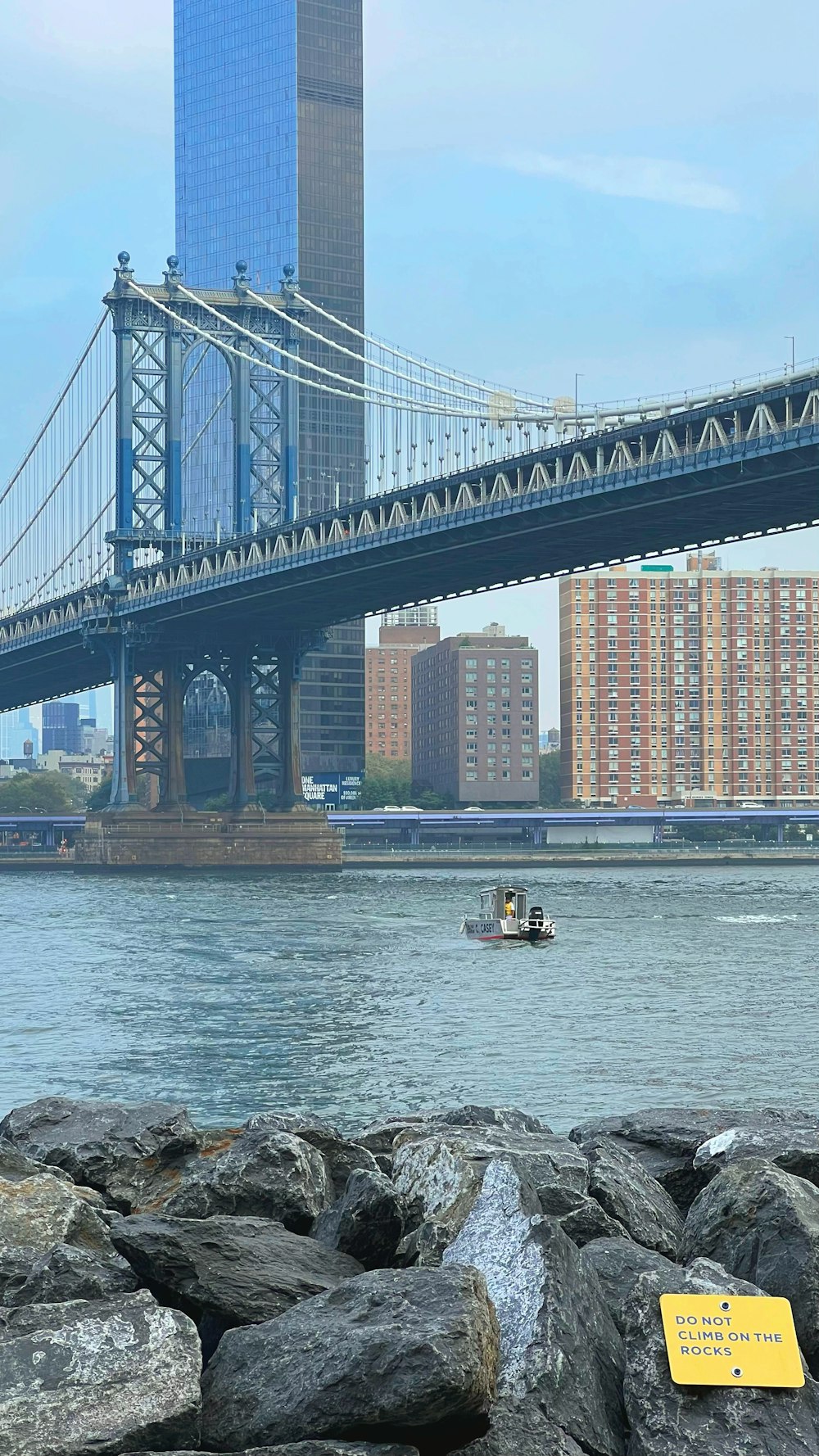 a boat on the water near a bridge