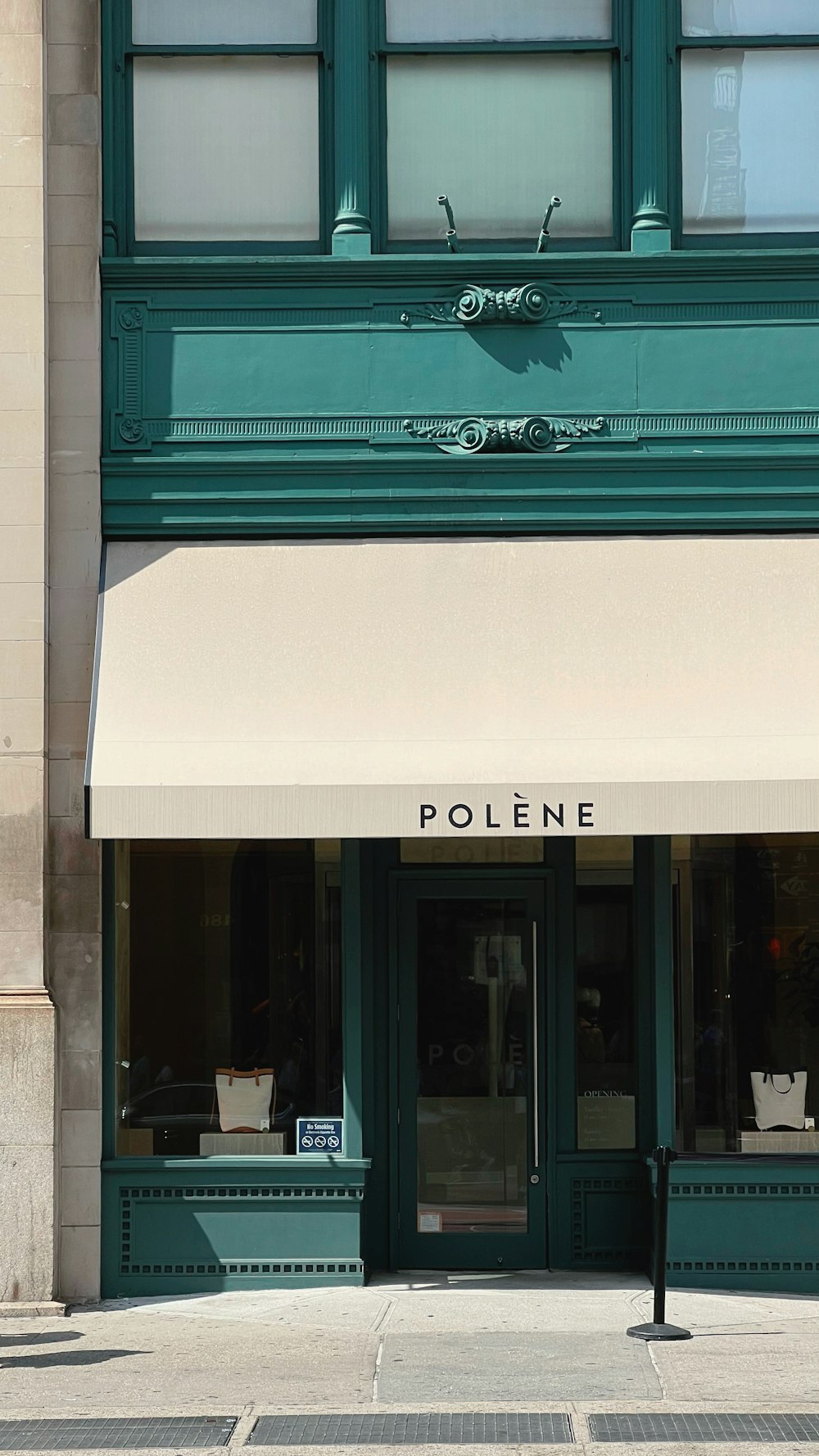 a store front with a white awning on a street corner