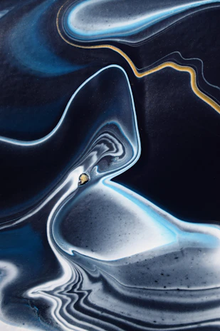 A mesmerizing fractal pattern in deep indigo and blue hues, swirling like a cosmic dance.