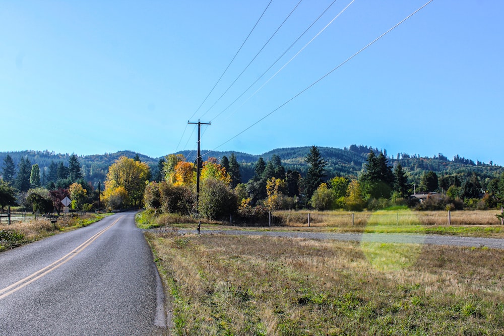 a rural road with power lines above it