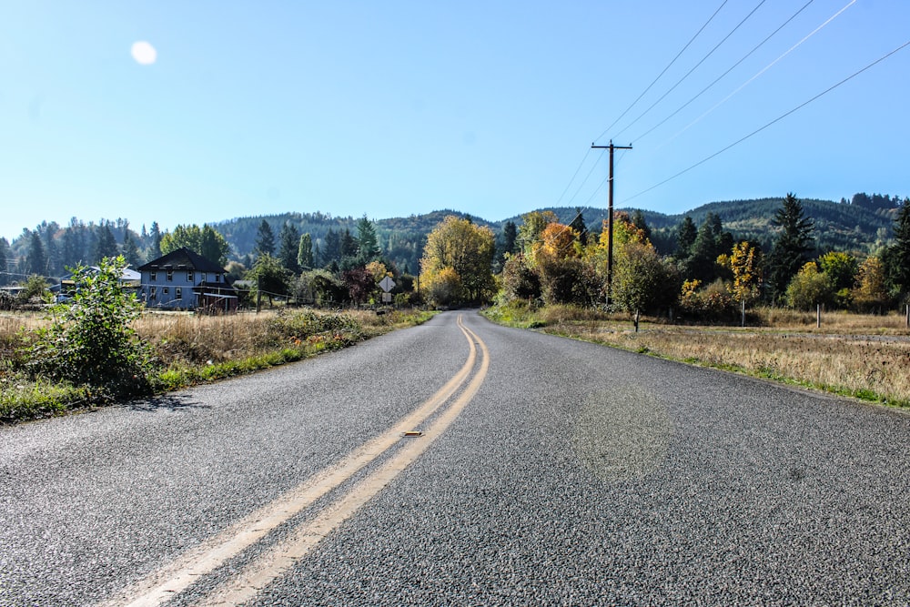 an empty road in the middle of a rural area