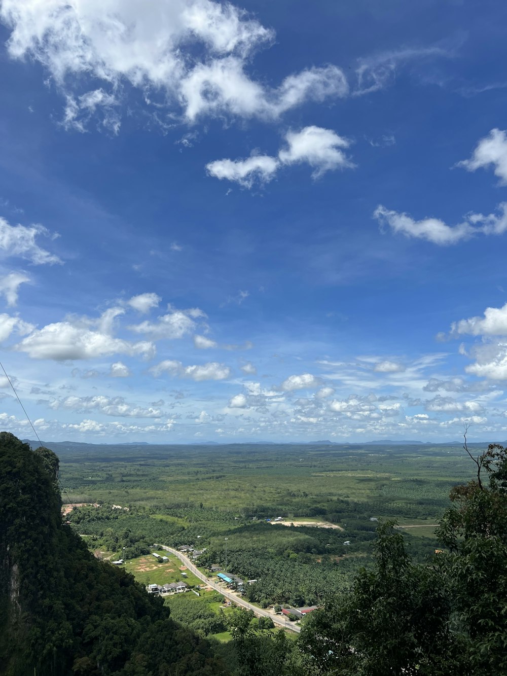 a scenic view of a green valley and a blue sky