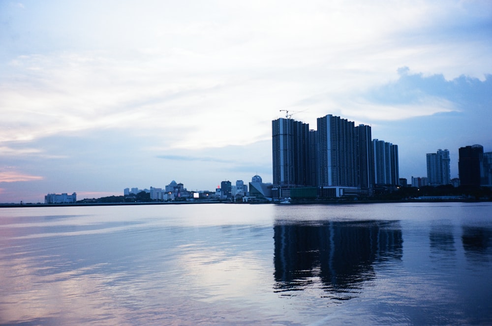 a body of water with buildings in the background