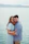 a man and a woman hugging by the water