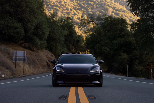 Sleek black taxi vehicle ready for a long-distance trip on a scenic highway in southern France.