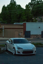 Sleek luxury car parked in an elegant urban setting at dusk