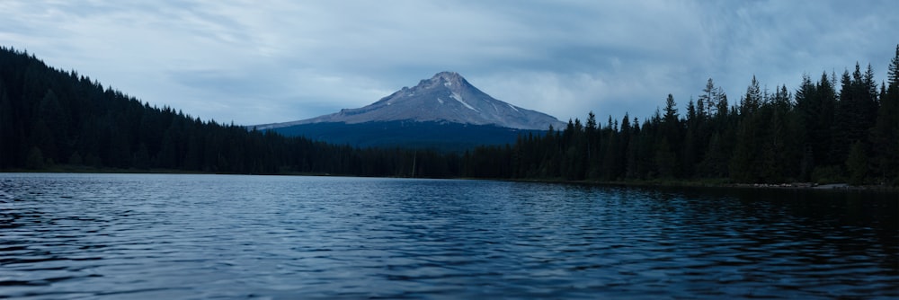 a mountain is seen in the distance from a lake