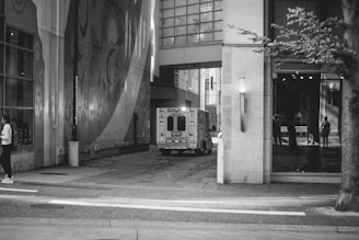 a black and white photo of a person walking down the street
