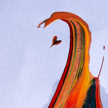 A splash of vibrant paint, creating an abstract form on a textured white background. The colors blend seamlessly, with sweeping lines and curves that evoke the shape of a bird in flight or an expressive figure.