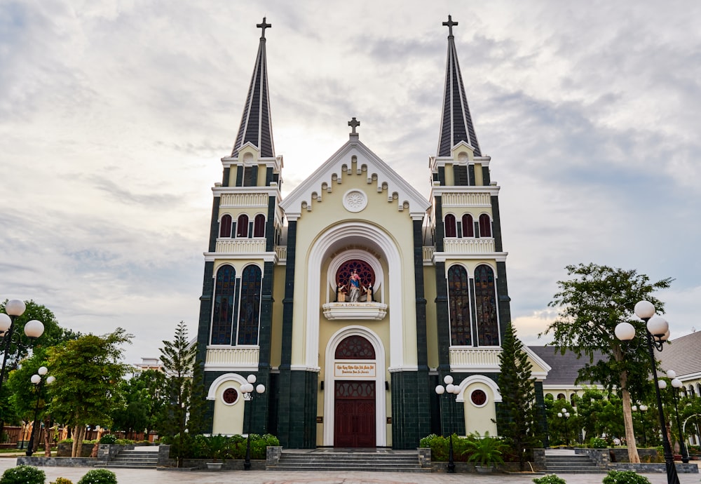 a church with two steeples and a clock on the front