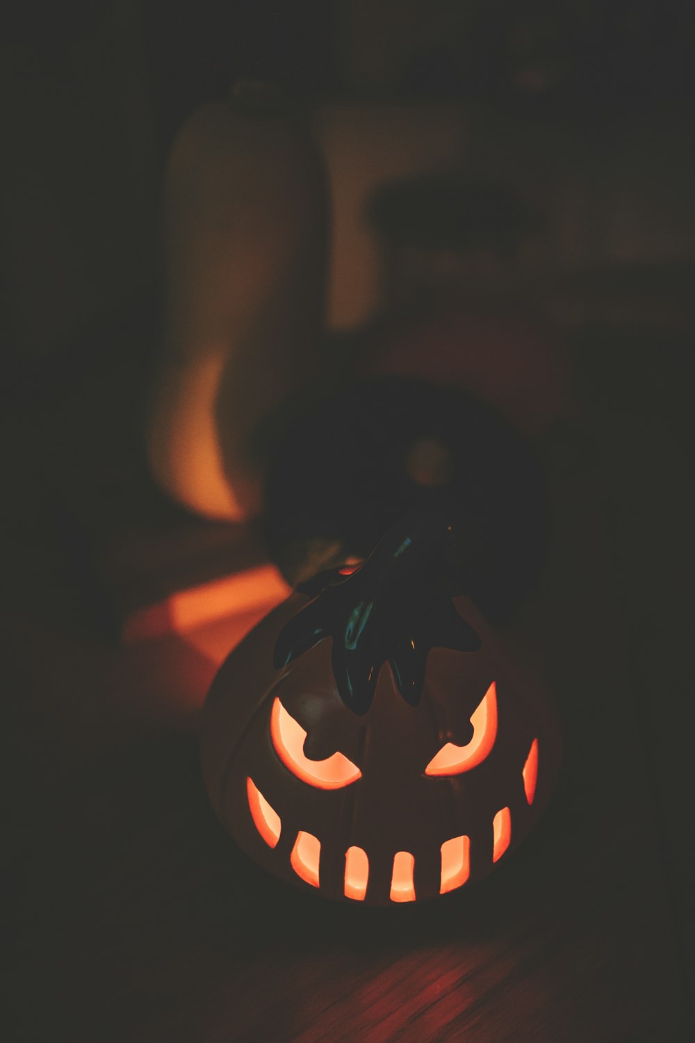 a pumpkin with glowing eyes on a table