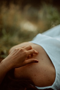 Close-up of hands gently resting on a calm belly, symbolizing body awareness and healing.