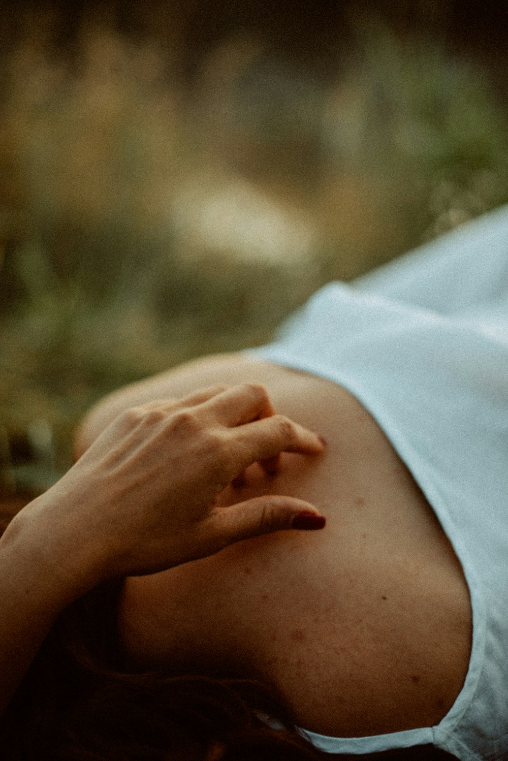 a woman laying down with her hand on her stomach