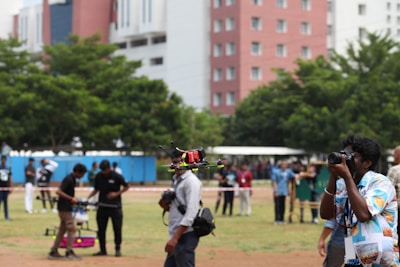 Instructor guiding a team through drone operation and safety protocols outdoors.