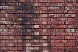 a close up of a brick wall made of red bricks
