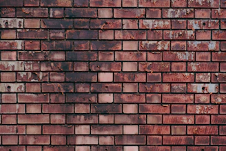 a close up of a brick wall made of red bricks