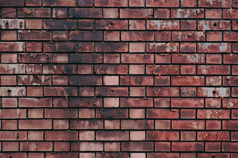 a close up of a brick wall made of red bricks