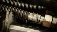 Industrial compression springs being tested for durability in a factory setting