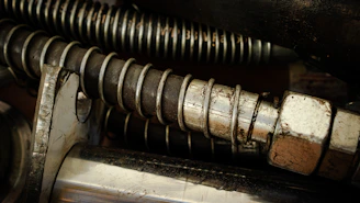 Close-up of precision-engineered coil springs stacked neatly in a workshop.