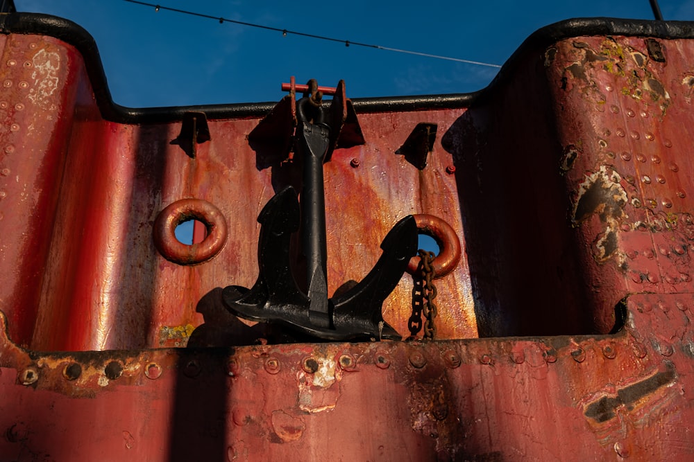 a rusted metal structure with a chain hanging from it