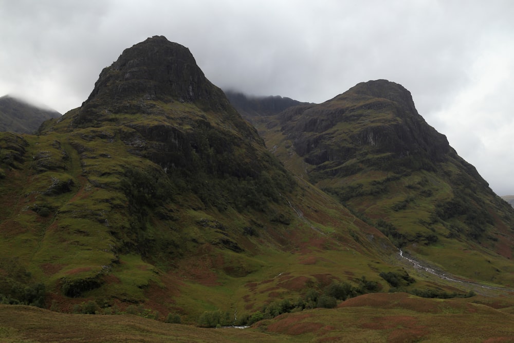 a mountain range with a stream running through it