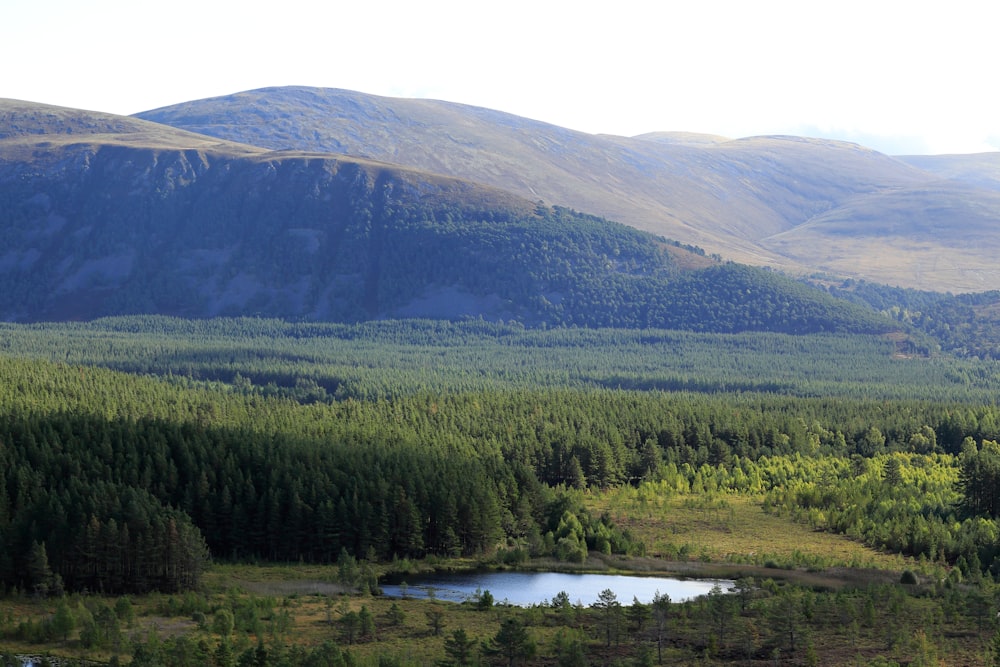 a view of a mountain range with a lake in the foreground