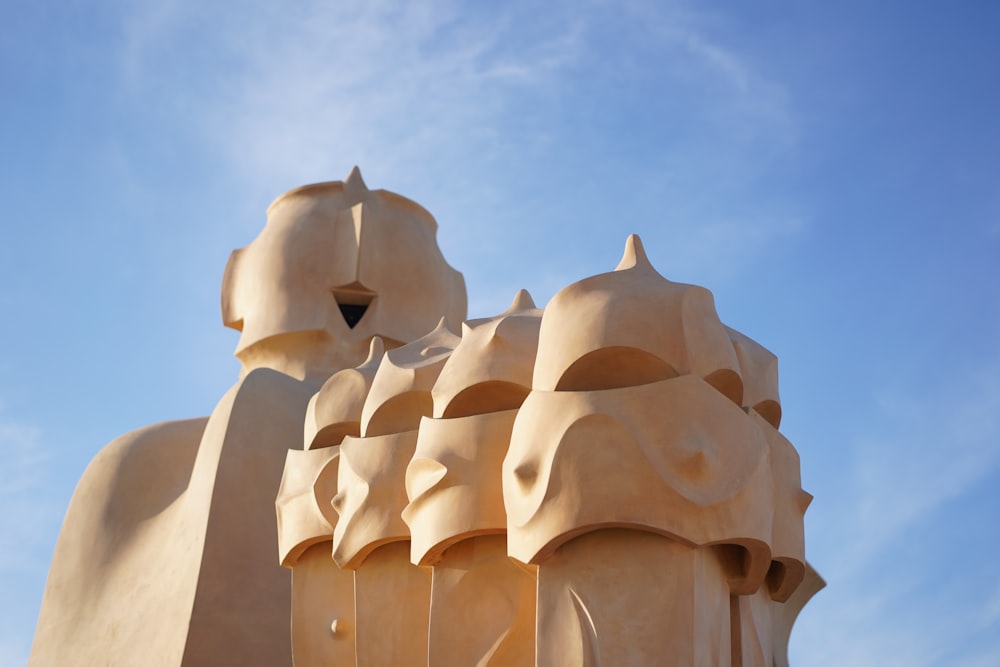 a statue of a group of elephants with a sky background