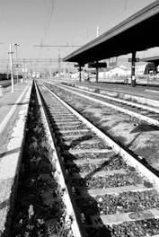 a black and white photo of a train track