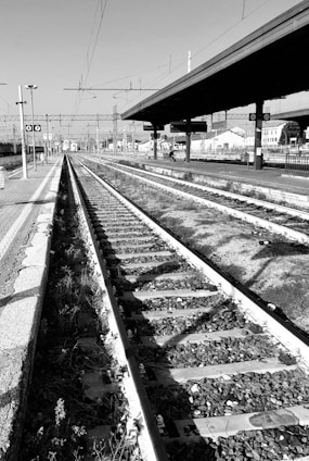 a black and white photo of a train track
