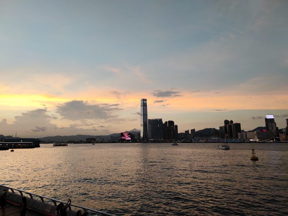 a large body of water with a city in the background