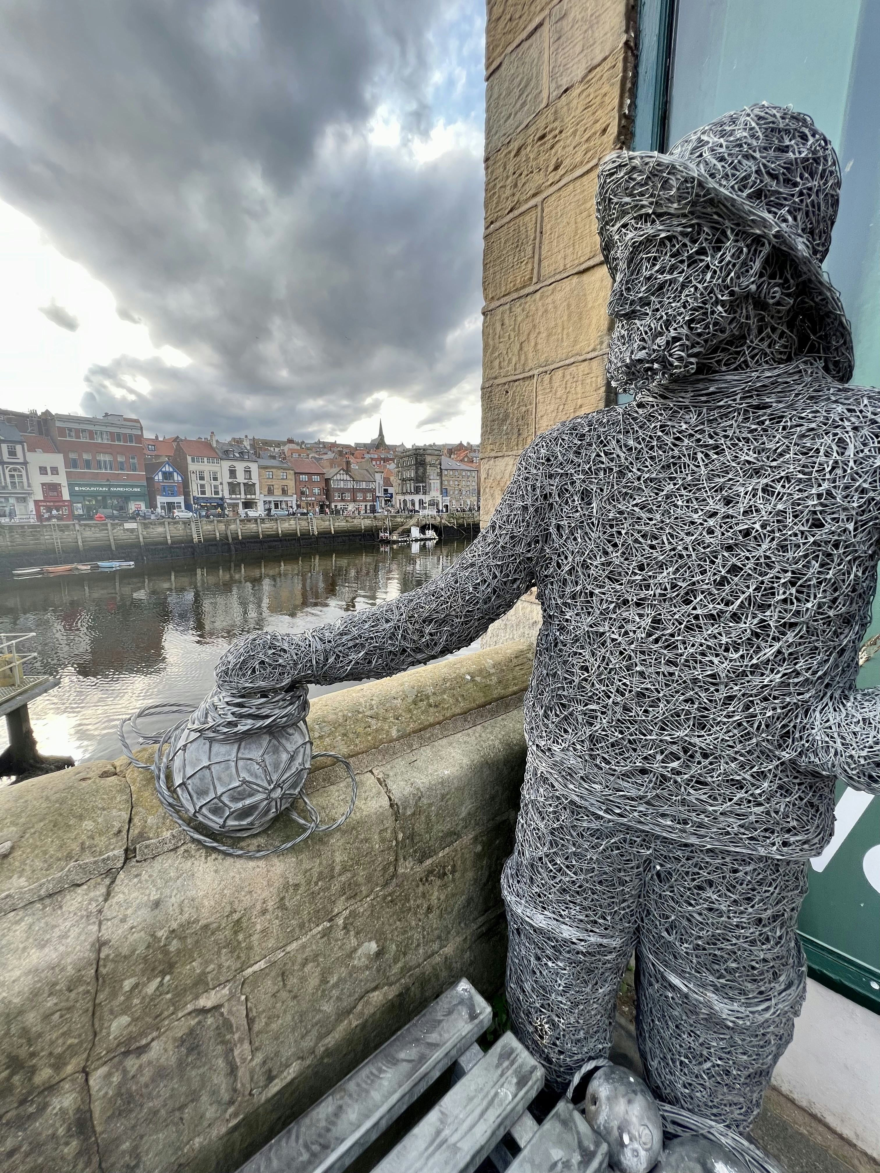 A statue of a man holding a fishing net photo – Free Whitby Image on ...