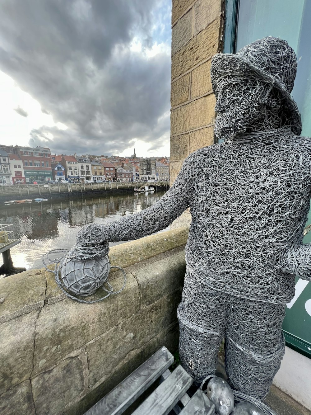 a statue of a man holding a fishing net