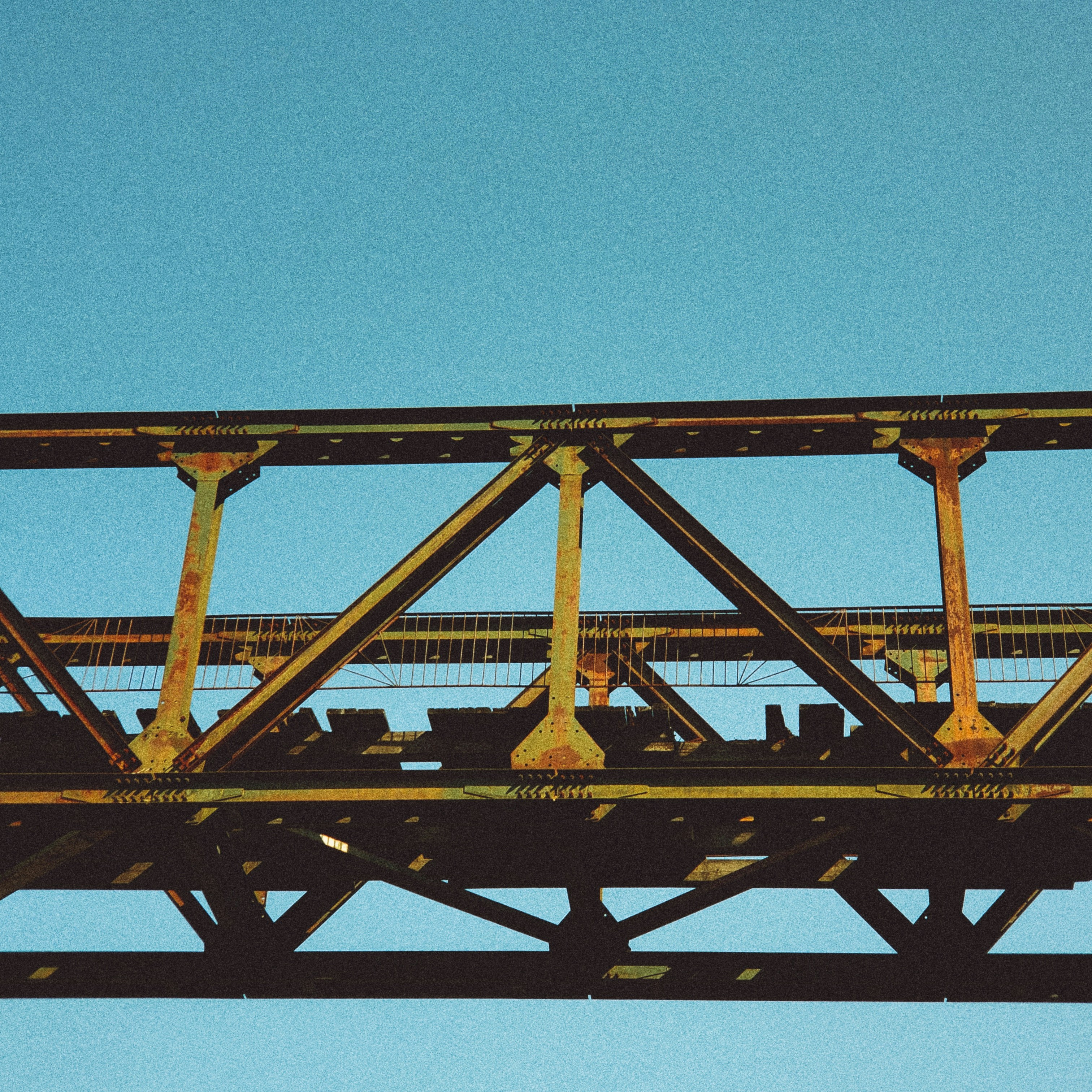 an airplane is flying over a bridge on a clear day