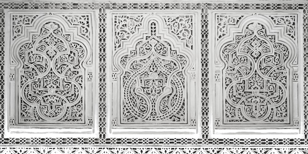 a white wall with intricate carvings on it