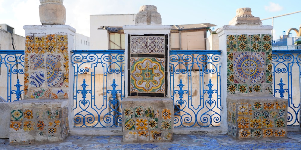a blue and white gate with a decorative design on it