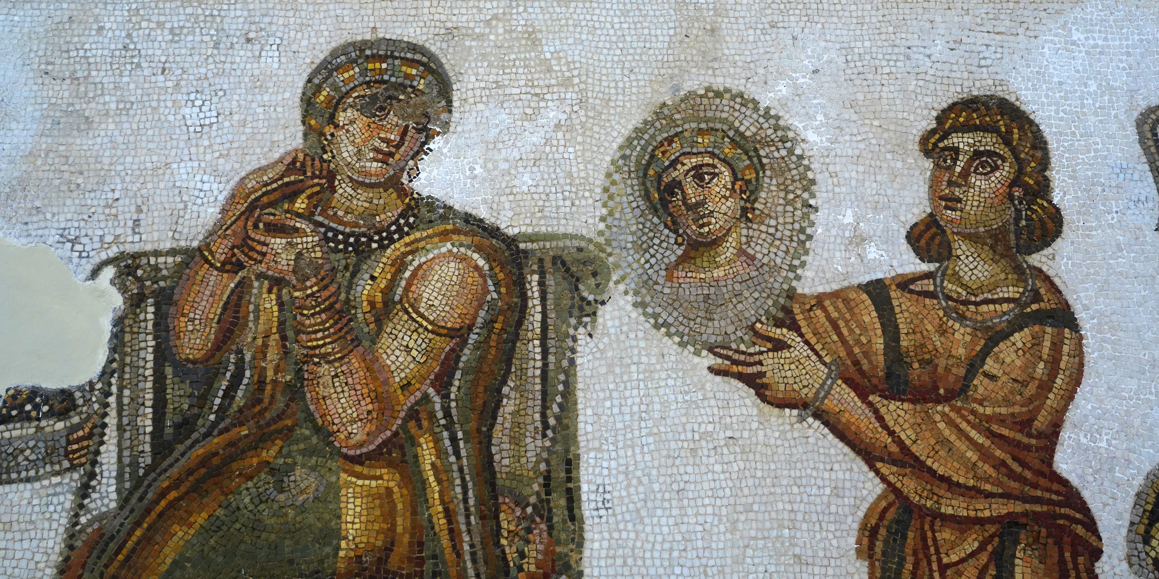 A Roman mosaic in the Bardo National Museum in Tunis: a seated woman in gold-trimmed robes and an attendant holding up a portrait medallion, worked in tiny coloured tesserae.