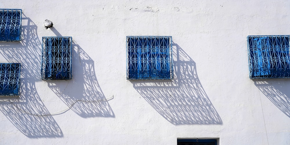 a white building with blue shutters on it