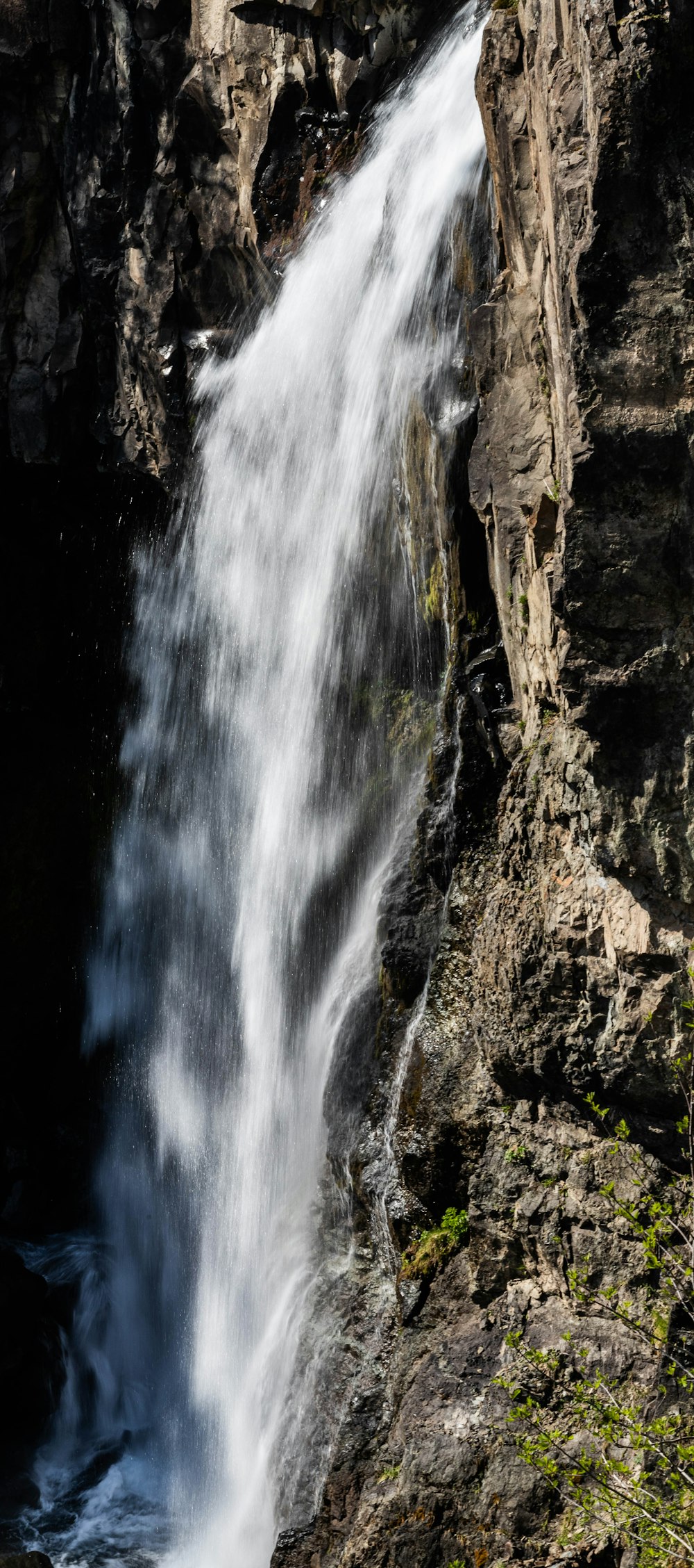 a large waterfall with water cascading down it's sides