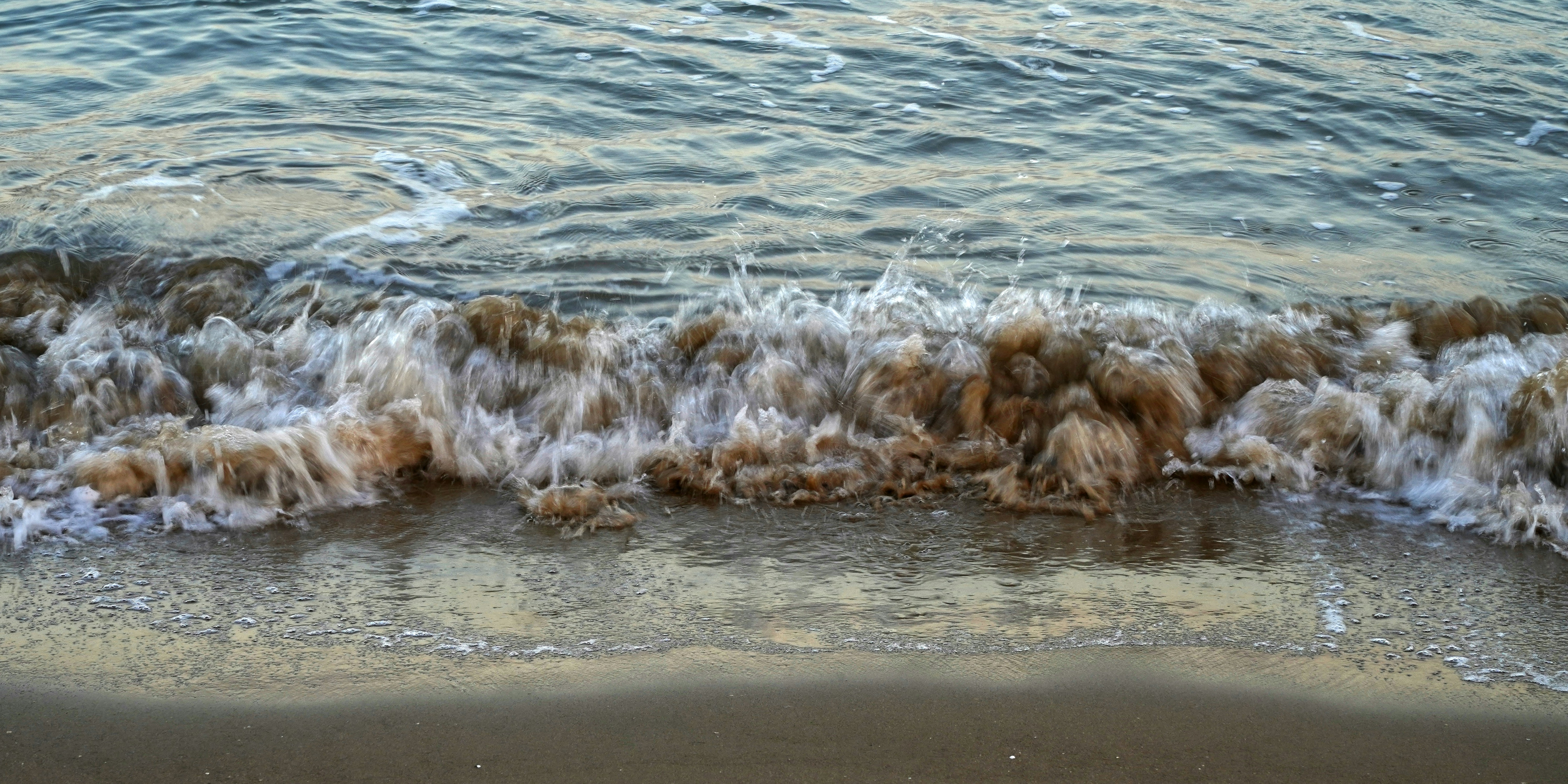 a beach with waves coming in and out of the water