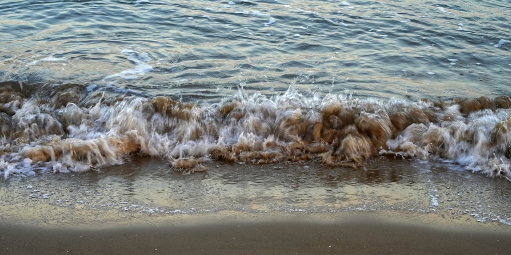 a beach with waves coming in and out of the water