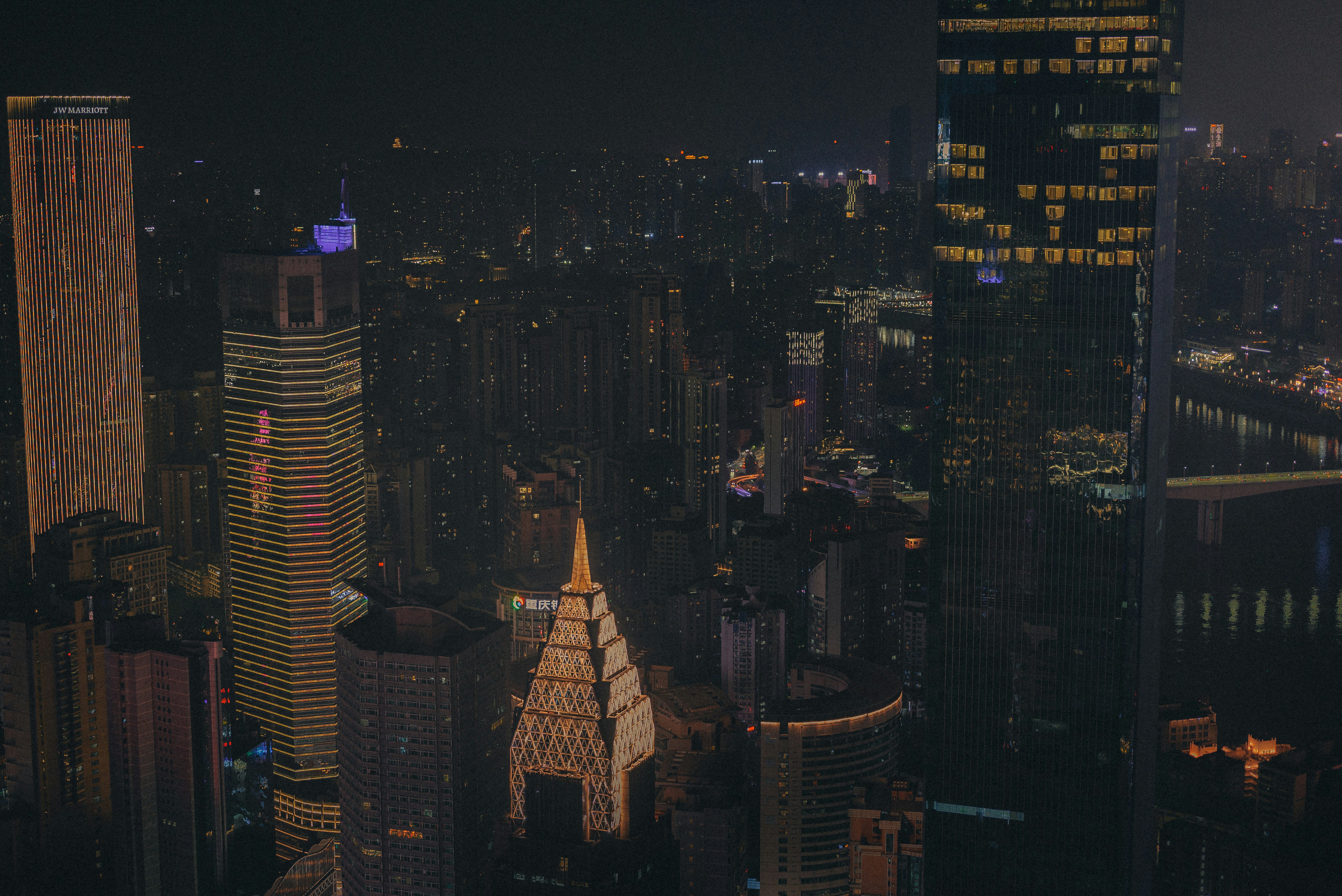 a view of a city at night from the top of a skyscraper