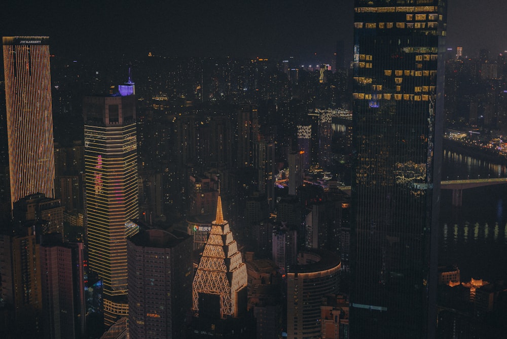 a view of a city at night from the top of a skyscraper