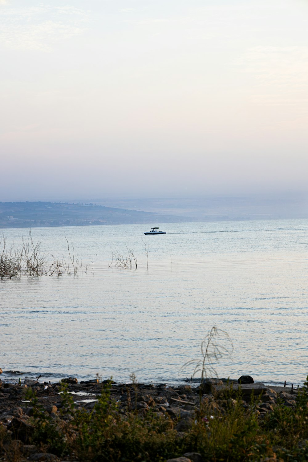 a lone boat in the middle of the ocean