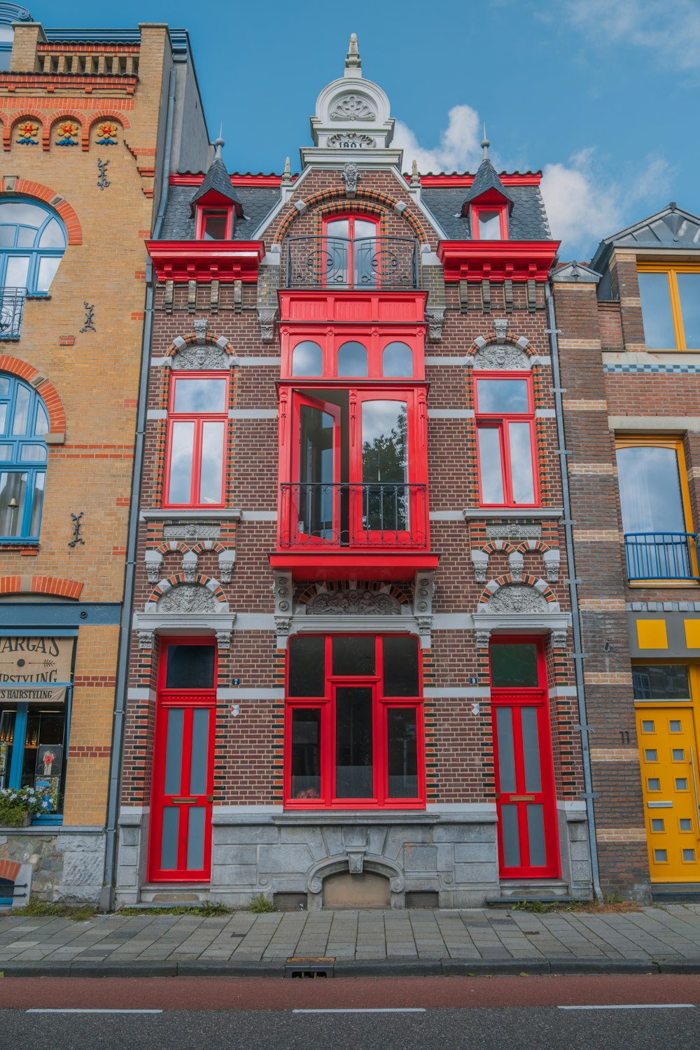 a red and yellow building with a clock on the top of it