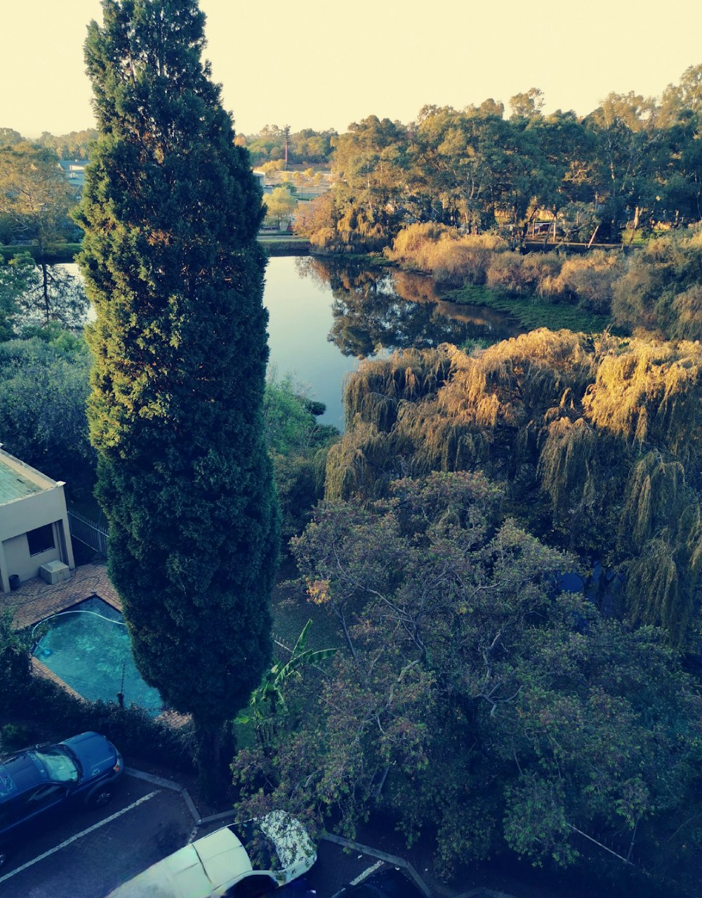 an aerial view of a river and a parking lot